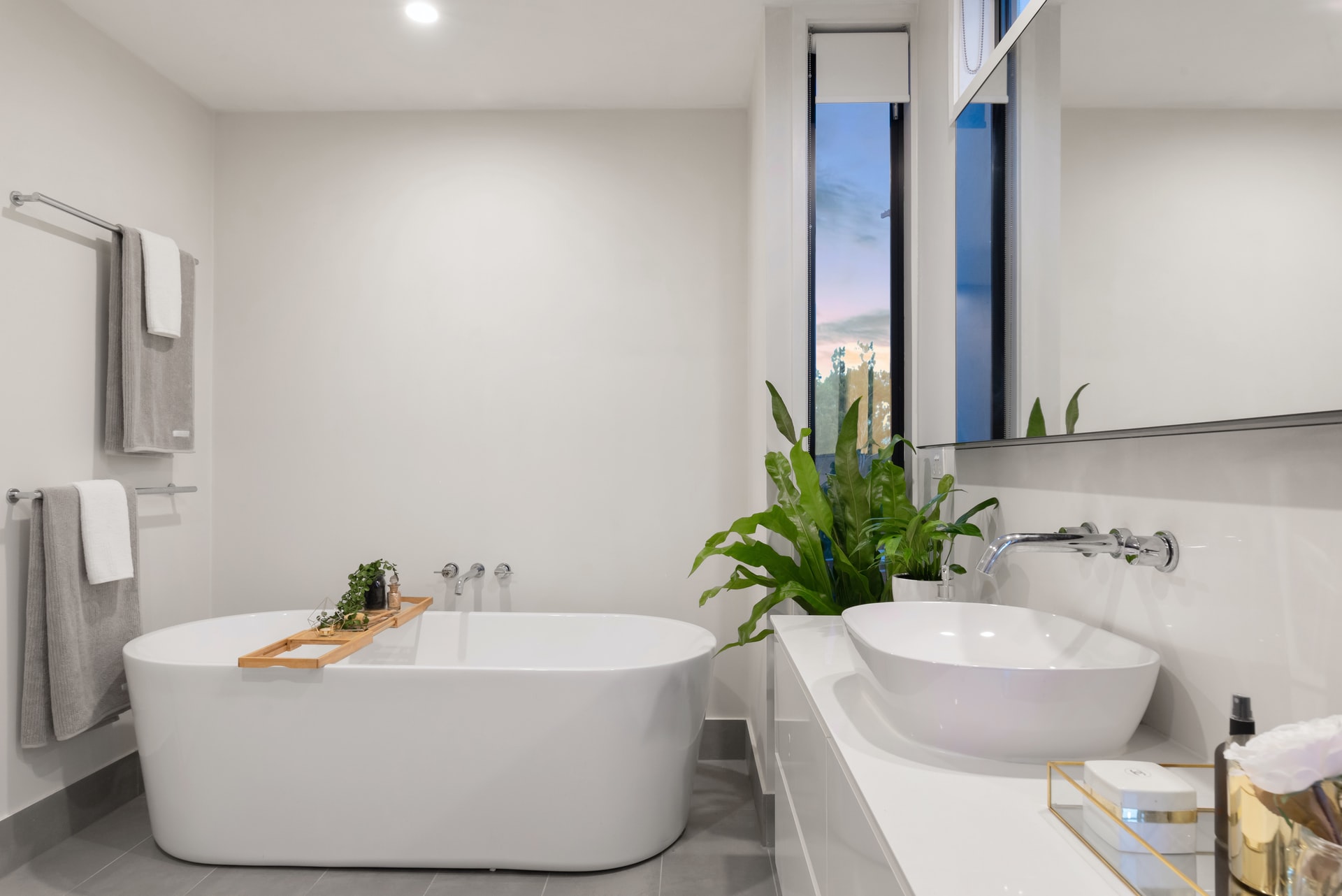 Primary bathroom with a freestanding tub beneath a window