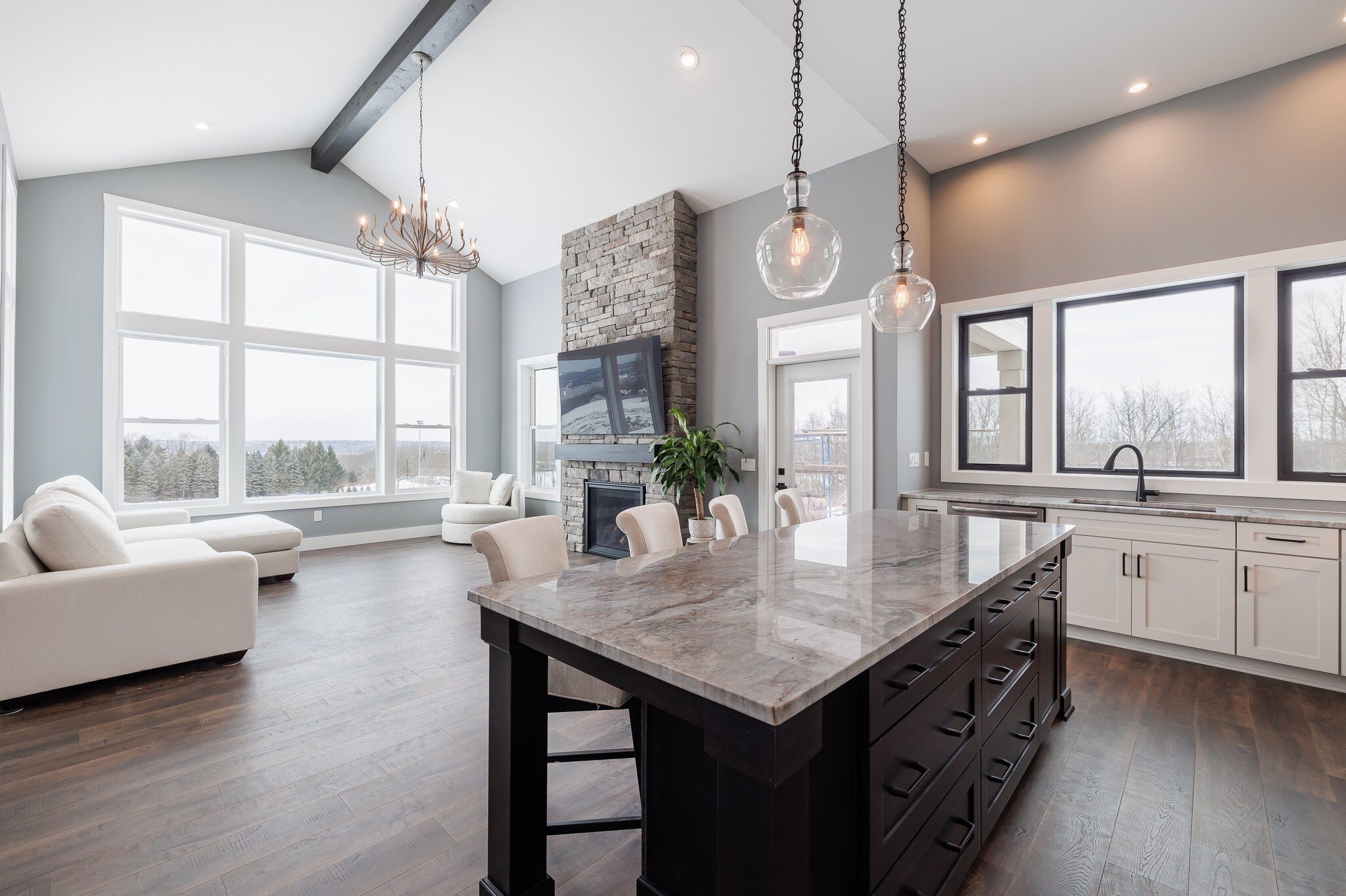 Open-concept kitchen and living space with a stone-topped island