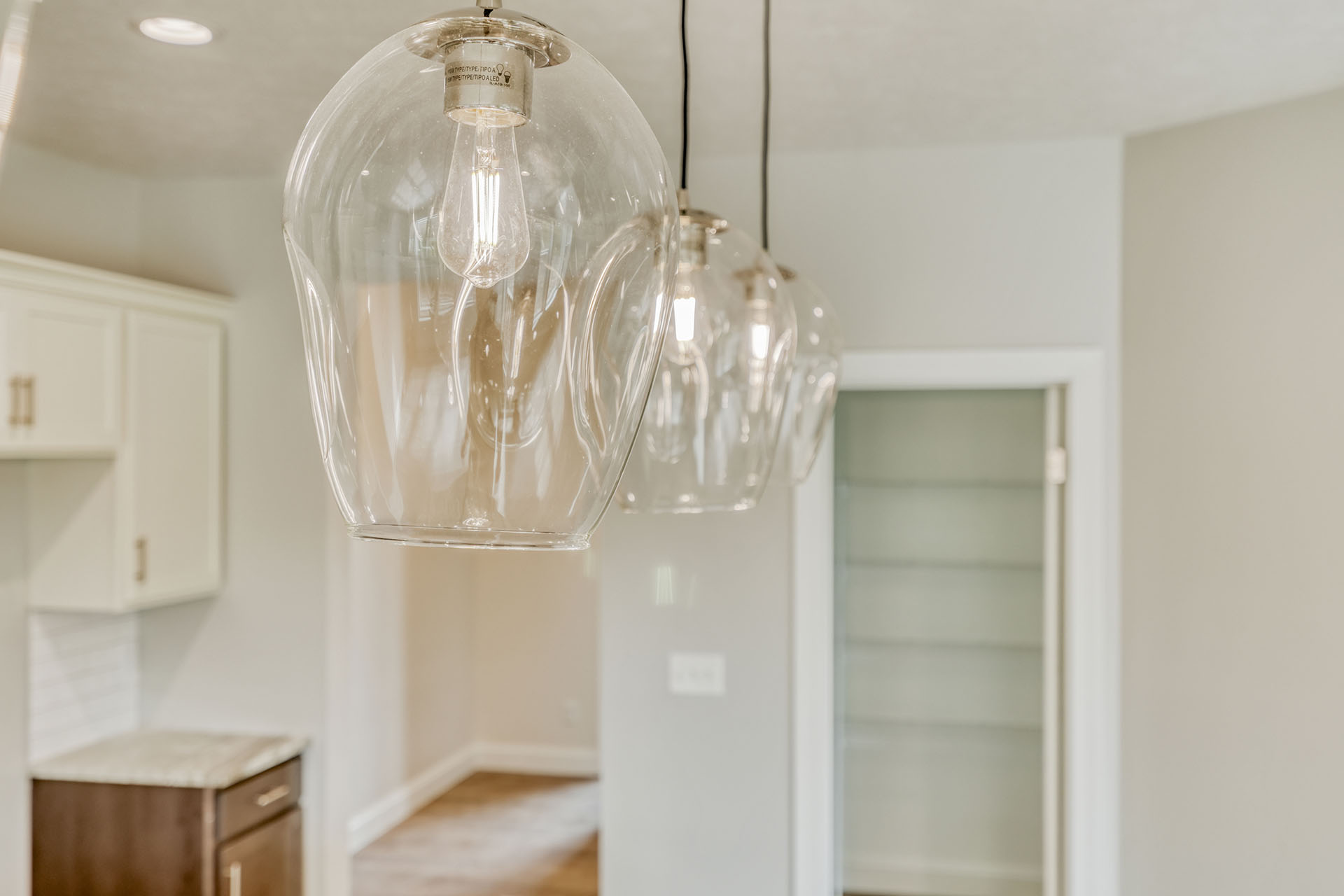 Glass bulb pendants hung over a kitchen island