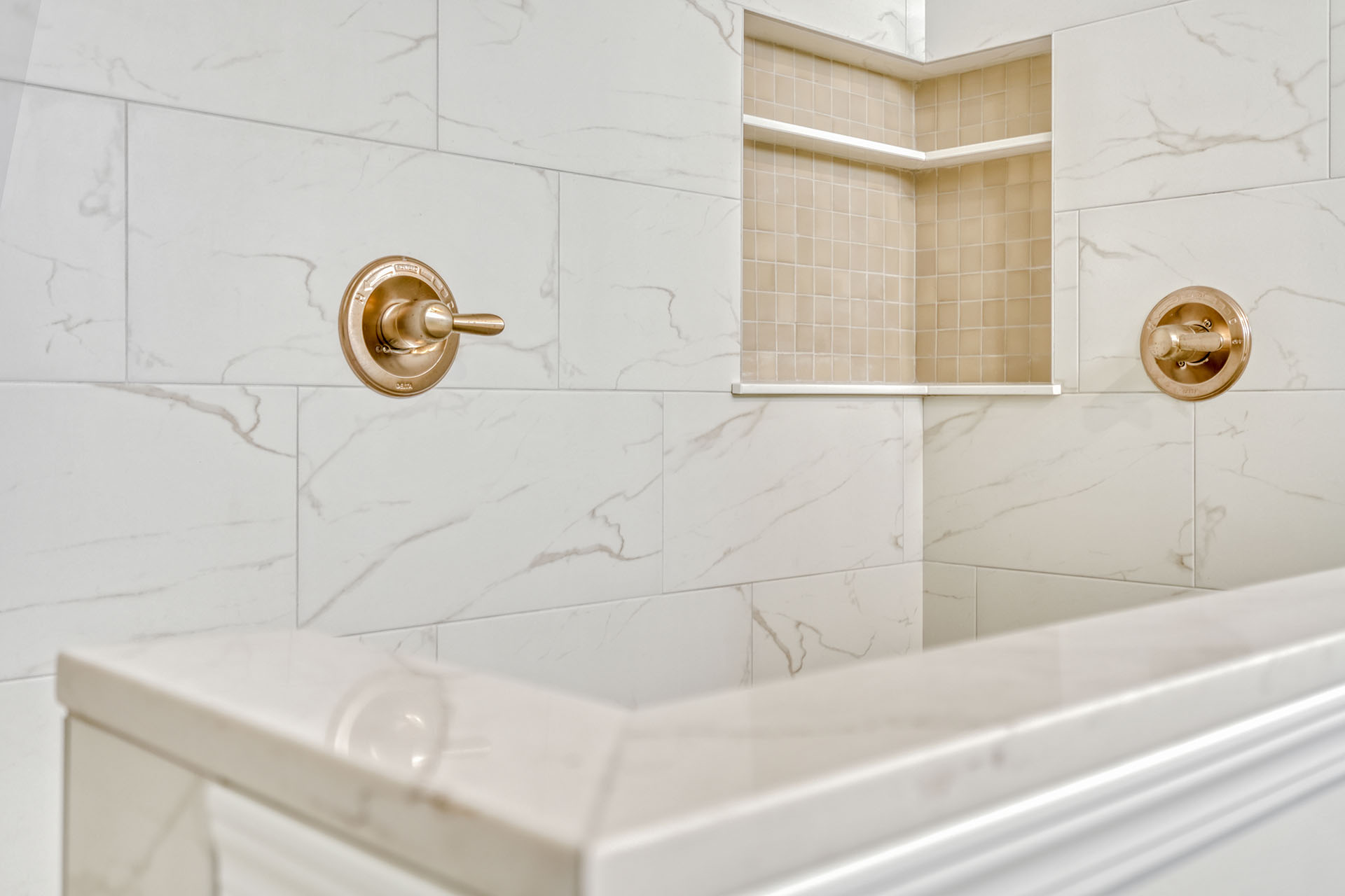 Tile detail and niche in a custom bathroom